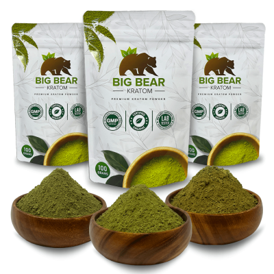 Three 100 gram Big Bear Kratom Stand Up Pouches with three wooden bowls of kratom powder.