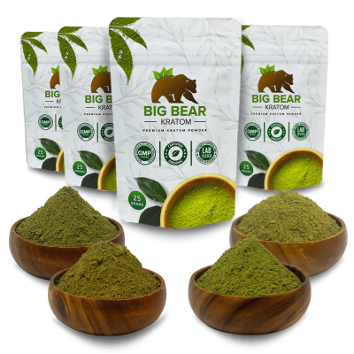 Four 25 gram Big Bear Kratom Bags in a row behind four bowls of kratom powder.