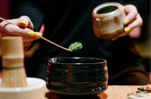 Woman preparing a botanical tea with green kratom