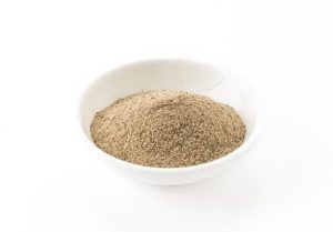 Fine red kratom powder after grinding — smooth texture and deep reddish-brown color
